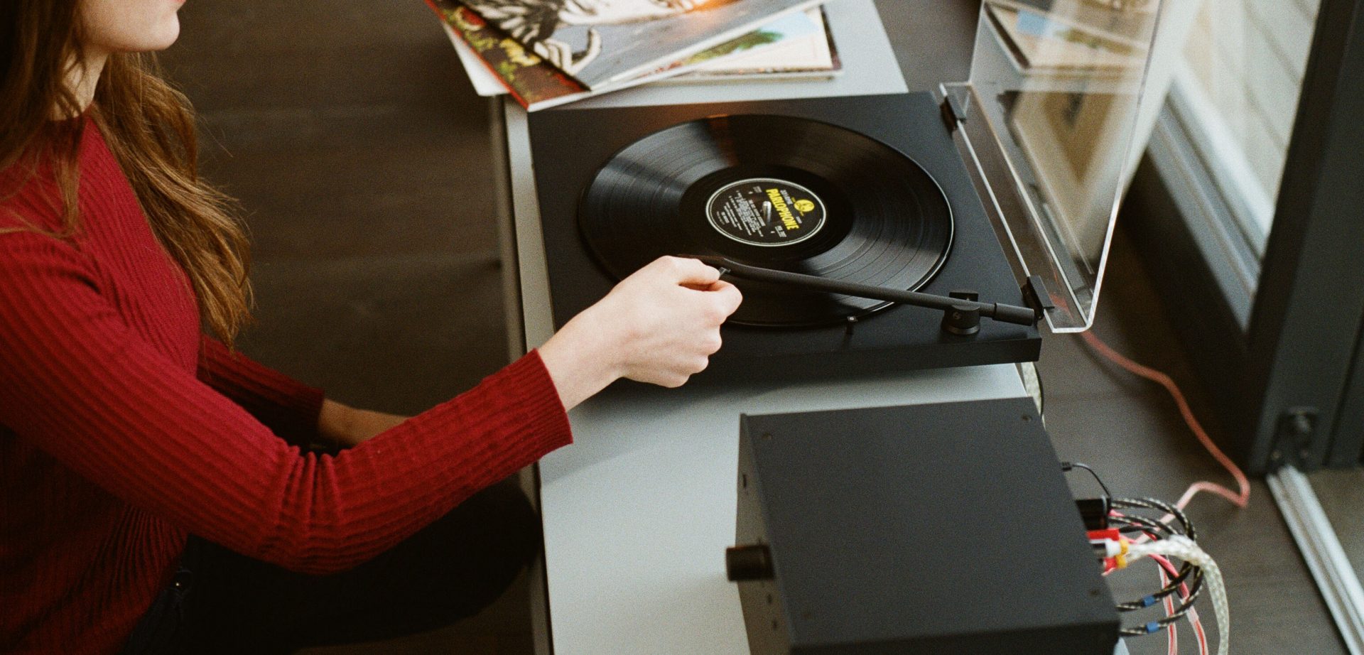 Person using the TONE turntable with TONE Amp
